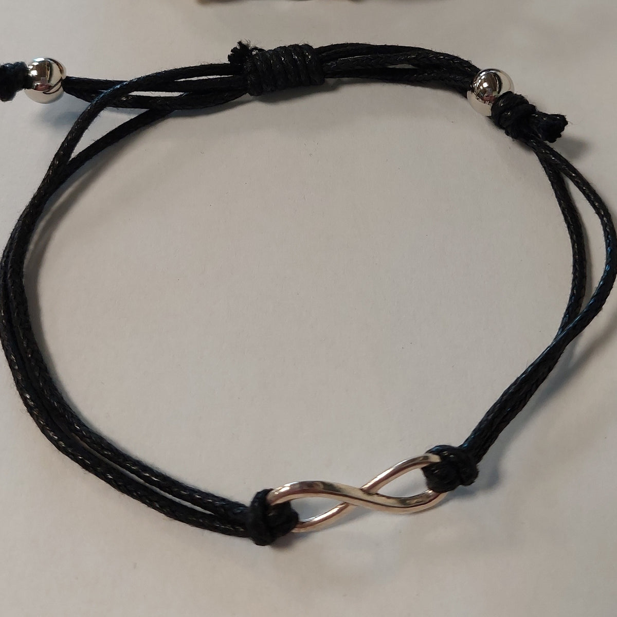 Sølv armbånd med kærligheds- og balance symbol