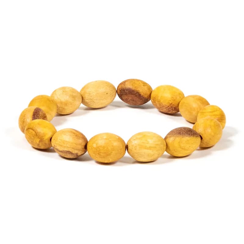 Palo Santo elastisk armbånd med ovale perler (± 6 mm). Er lavet af bæredygtigt høstet Palo Santo.  Armbåndet er håndlavet i mindre workshops og med øje for håndværkerens og naturens ve og vel. De oprindelige folk i Andesbjergene har i århundreder brugt Palo Santo til at afværge negativ energi. Når dette hellige træ brændes, renses negativ energi, fred og harmoni genoprettes og forbindelsen med moder jord styrkes. 
